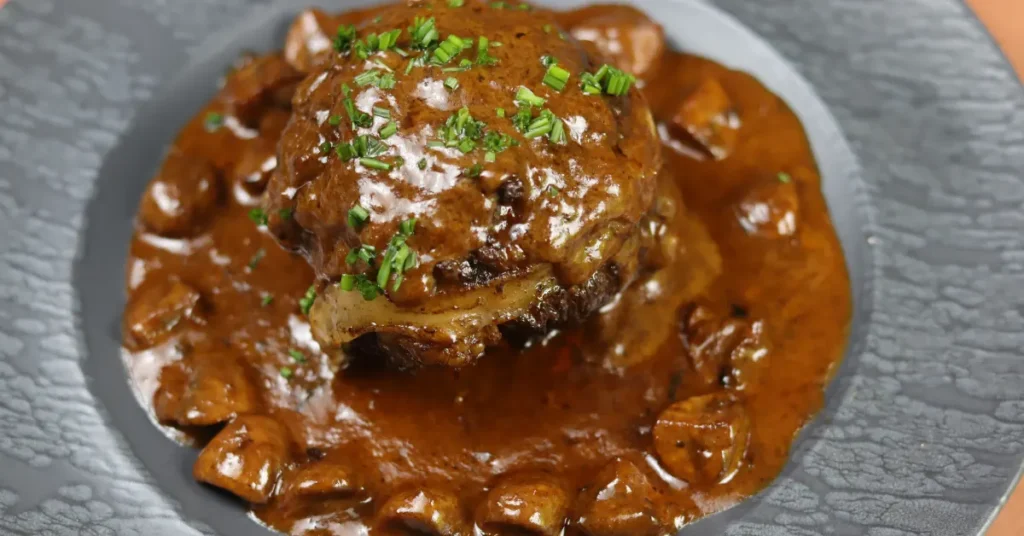 Traditional French Veal Paupiette filled with seasoned ground meat, wrapped in veal cutlets, and served with a rich creamy mushroom sauce by comfortfoodrecipes.net