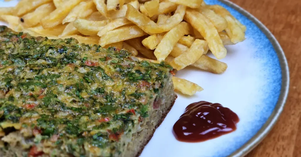 Traditional Egyptian Omelette (Egyptian eggah) baked to perfection, served with fresh herbs and vegetables